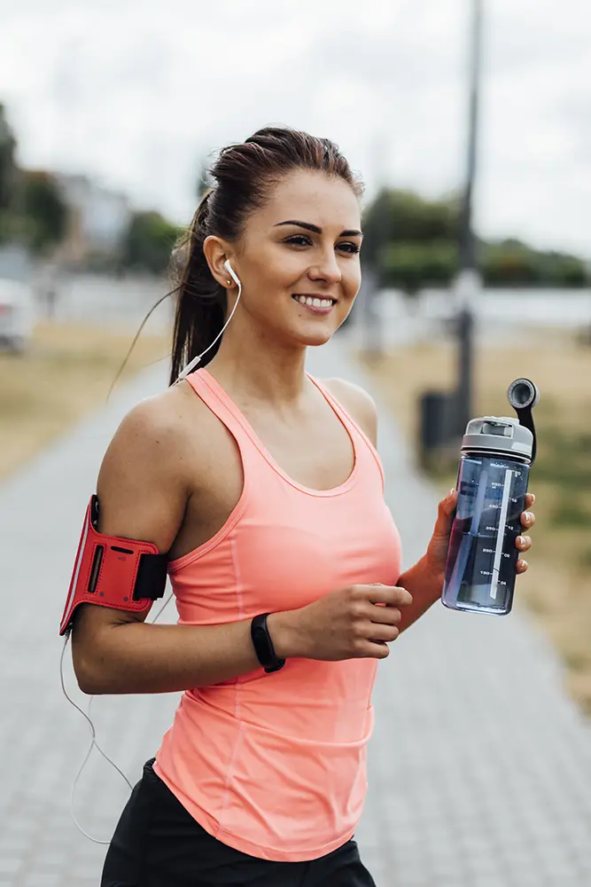 Smiling woman holding water bottle